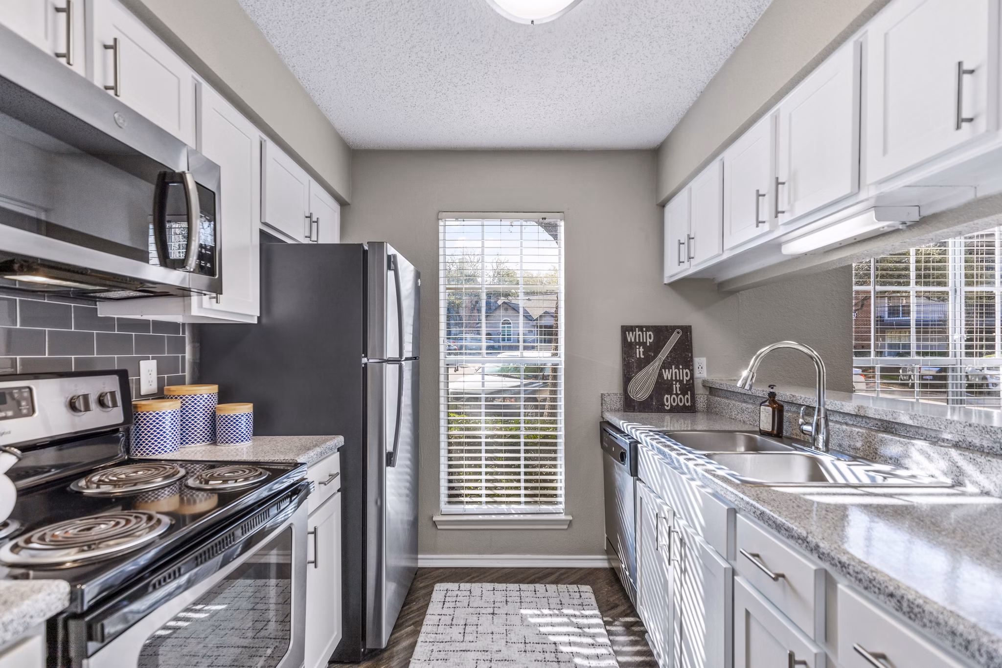 Modern kitchen with stainless steel appliances in The Georgian Apartments