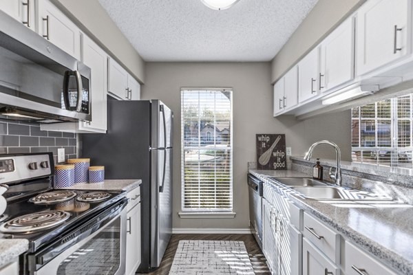 Modern kitchen with stainless steel appliances in The Georgian Apartments