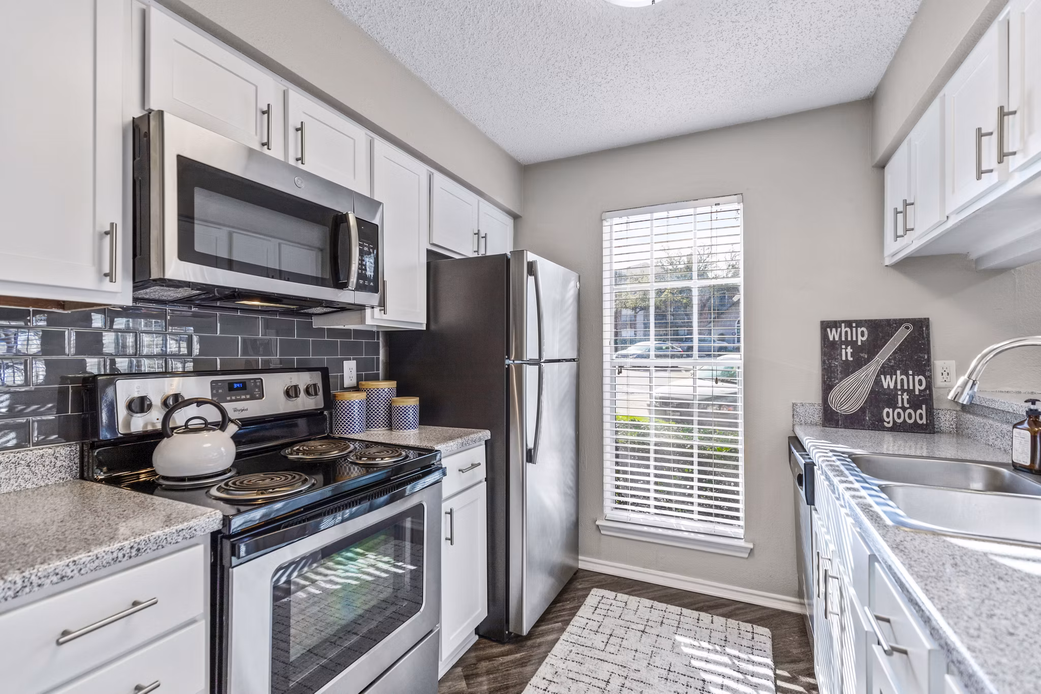 Modern kitchen with sleek countertops and stainless steel appliances at The Georgian Apartments