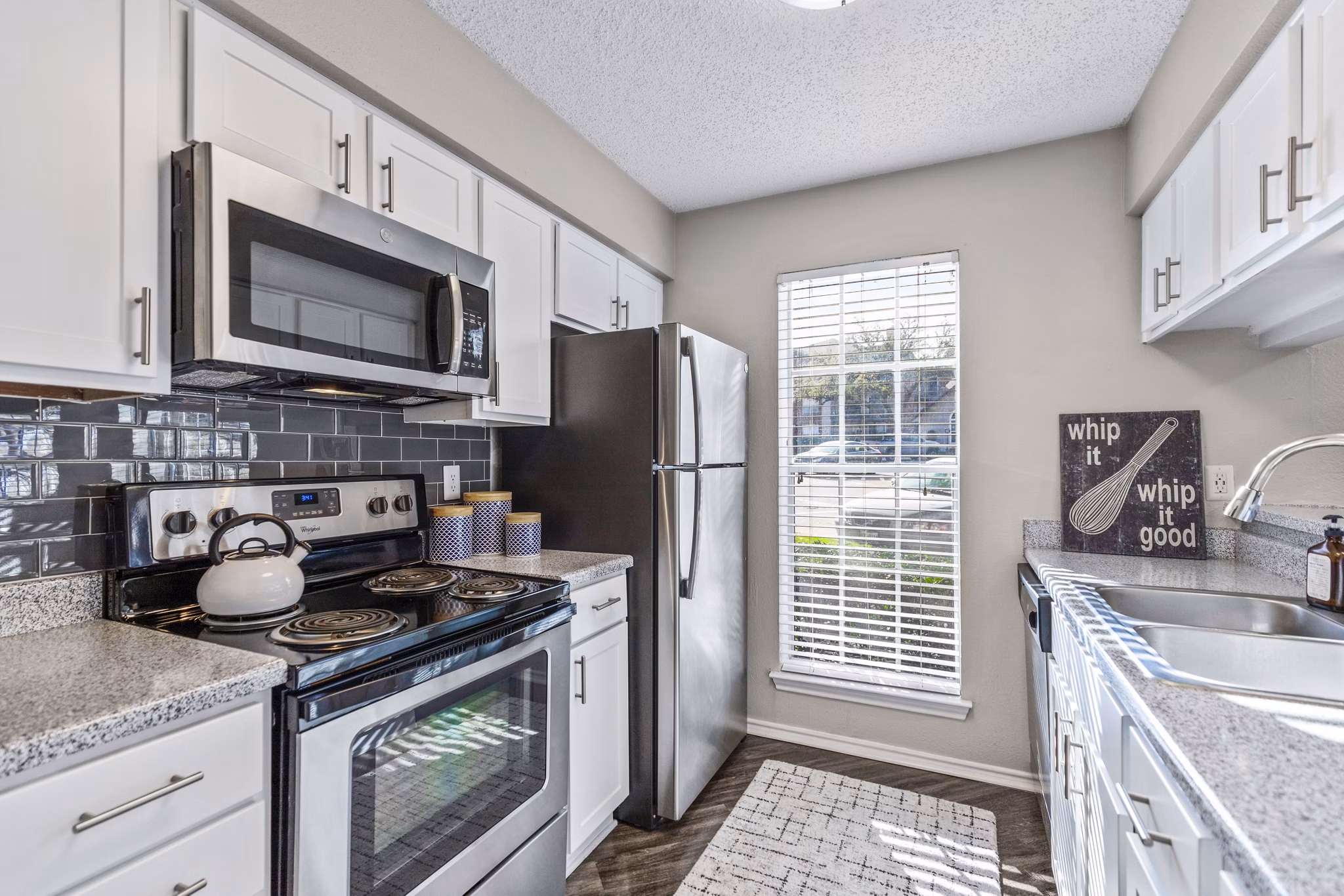 Modern kitchen with sleek countertops and stainless steel appliances at The Georgian Apartments