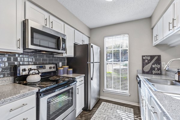 Modern kitchen with sleek countertops and stainless steel appliances at The Georgian Apartments