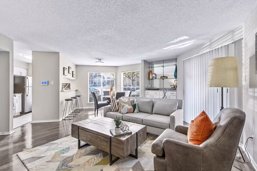 Spacious living room with modern decor and ample natural light in The Georgian Apartments