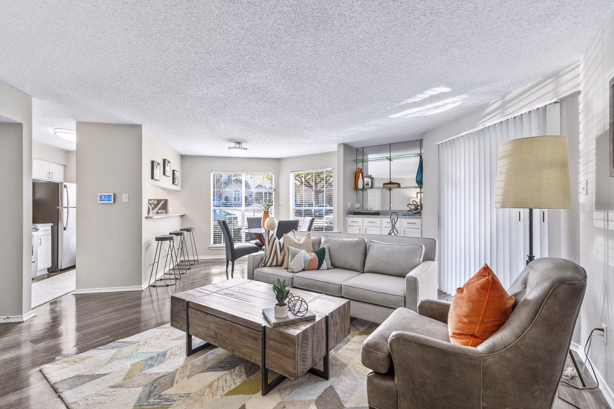 Spacious living room with modern decor and ample natural light in The Georgian Apartments