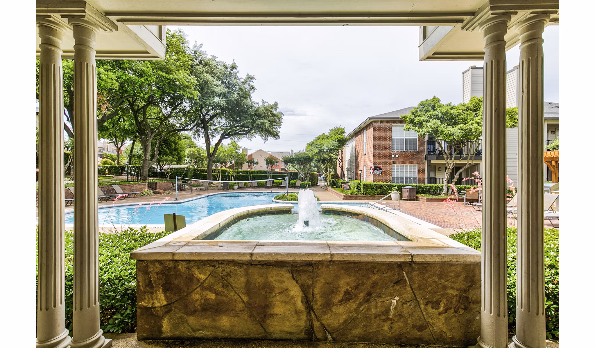 Resort-style pool with lounge chairs at The Georgian Apartments offering luxury living in a tranquil setting