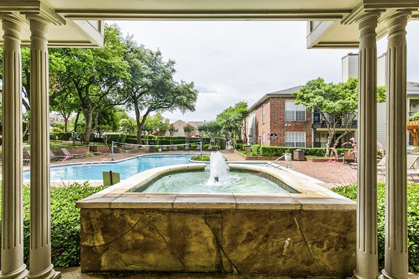 Resort-style pool with lounge chairs at The Georgian Apartments offering luxury living in a tranquil setting