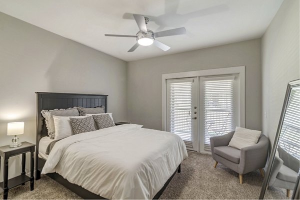 Bedroom with modern furnishings in Regal Parc Apartments