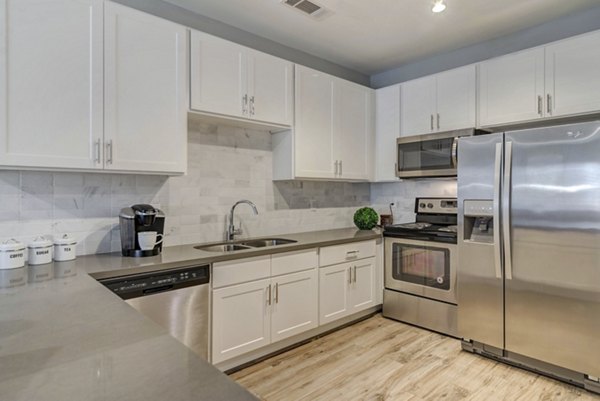 Modern kitchen with stainless steel appliances at Regal Parc Apartments Apartments