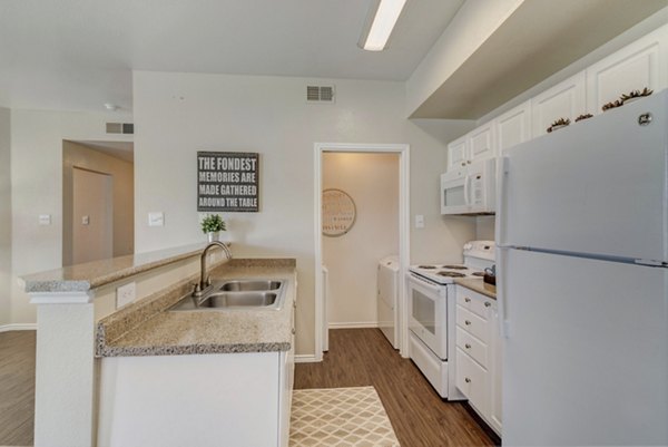 Modern kitchen featuring stainless steel appliances at Regal Parc Apartments