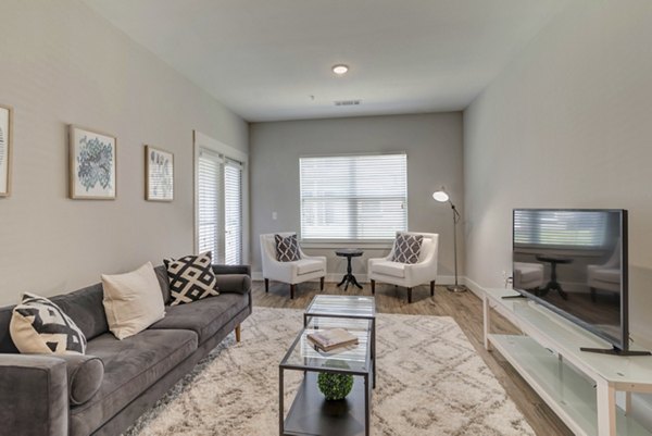 Modern living room with elegant decor and natural lighting at Regal Parc Apartments