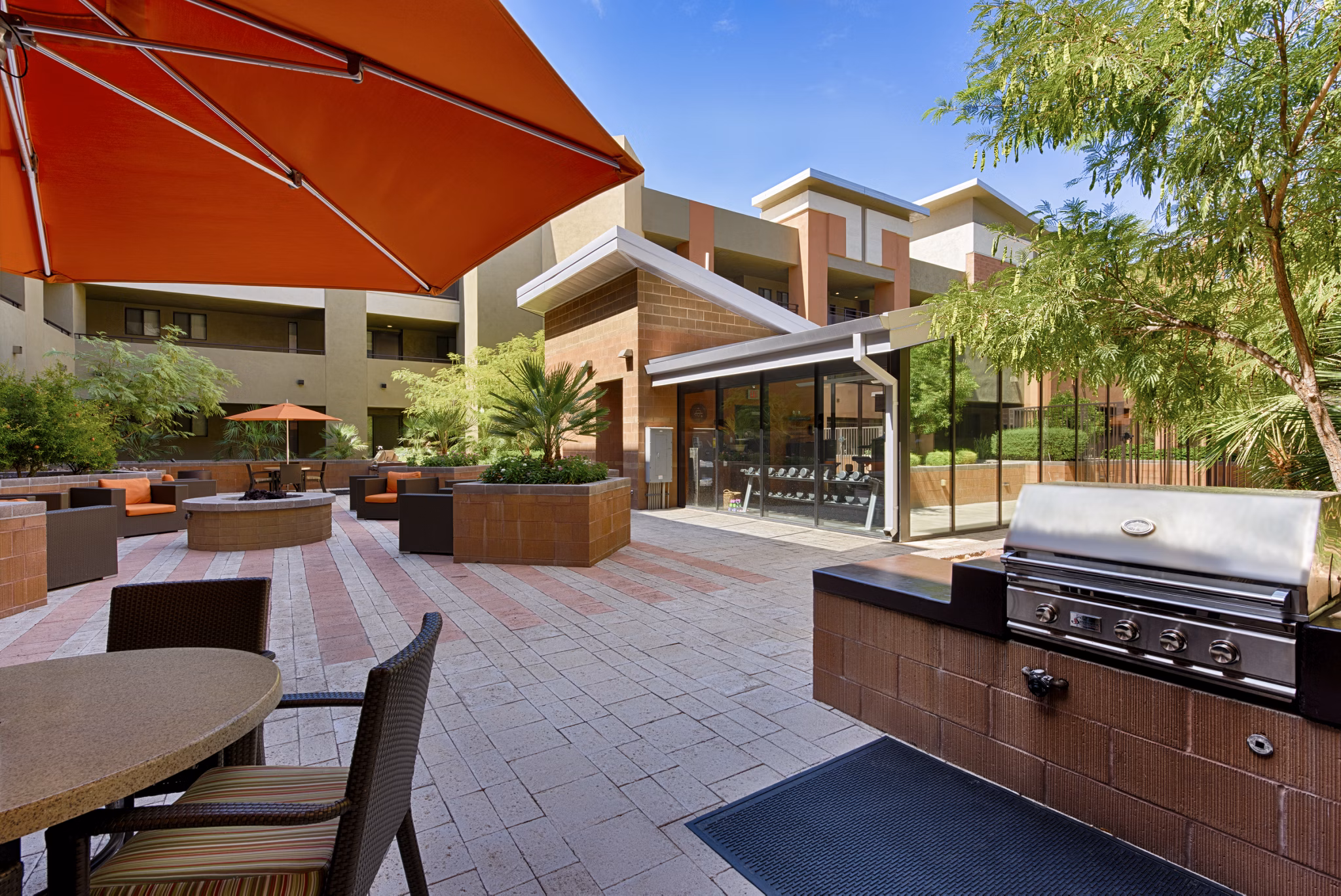 Outdoor grill area with modern seating at Ten Wine Lofts Apartments for social gatherings and leisure