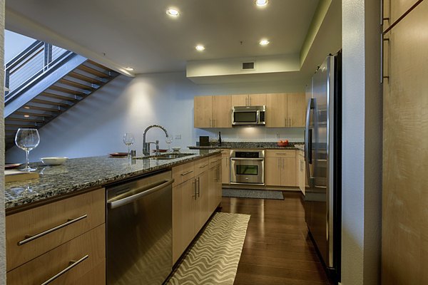 Modern kitchen with stainless steel appliances in Ten Wine Lofts Apartments