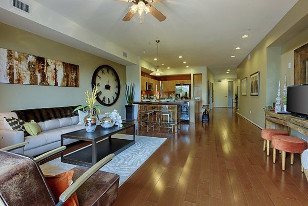 Luxurious living room with modern dÃ©cor at Ten Wine Lofts Apartments in Scottsdale, featuring ample natural light and elegant furnishings