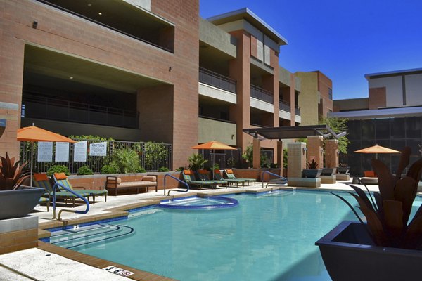 Modern pool area with loungers at Ten Wine Lofts Apartments in Scottsdale, perfect for relaxation and leisure activities