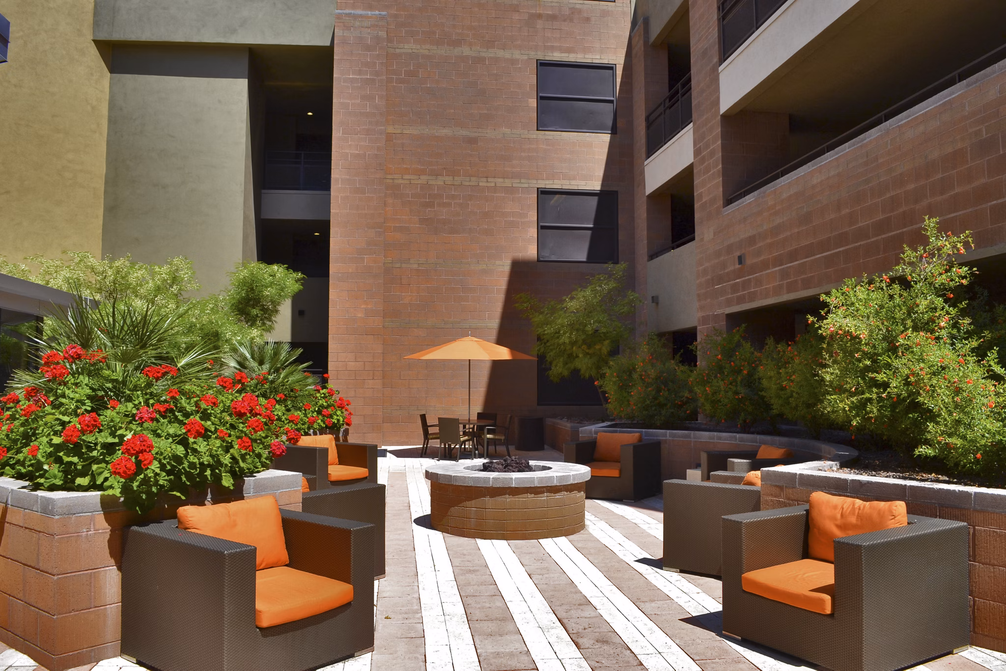 Fire pit lounge area with cozy seating at Ten Wine Lofts Apartments, perfect for outdoor relaxation and social gatherings