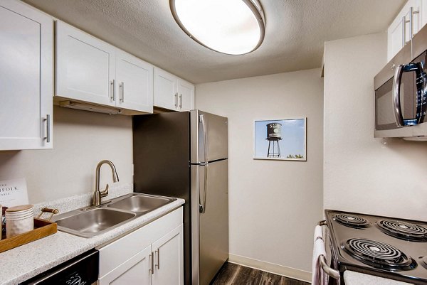 Modern kitchen with sleek countertops and stainless steel appliances at Canyon Reserve at the Ranch Apartments
