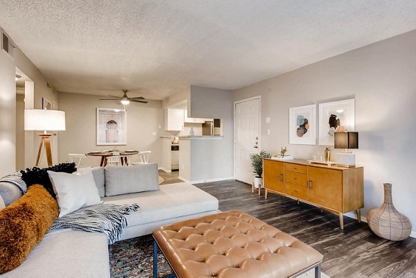 Living room with modern furnishings and natural light at Canyon Reserve at the Ranch Apartments