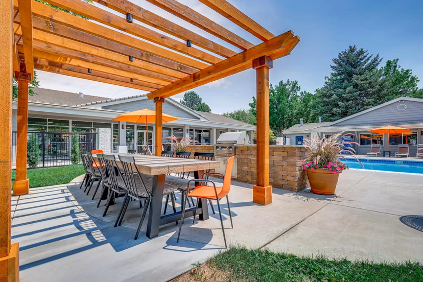 Patio with modern seating and mountain views at Canyon Reserve at the Ranch Apartments