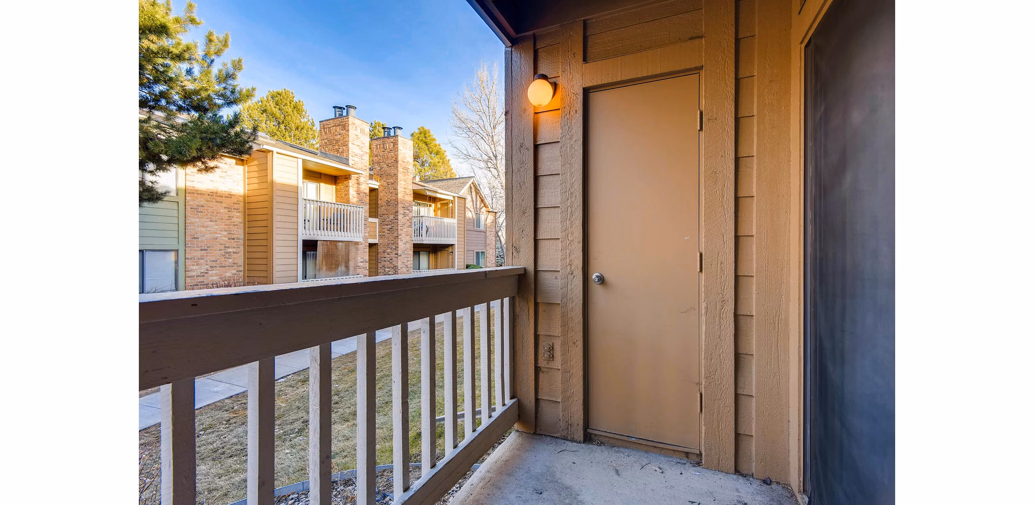Patio with modern seating and mountain views at Canyon Reserve at the Ranch Apartments