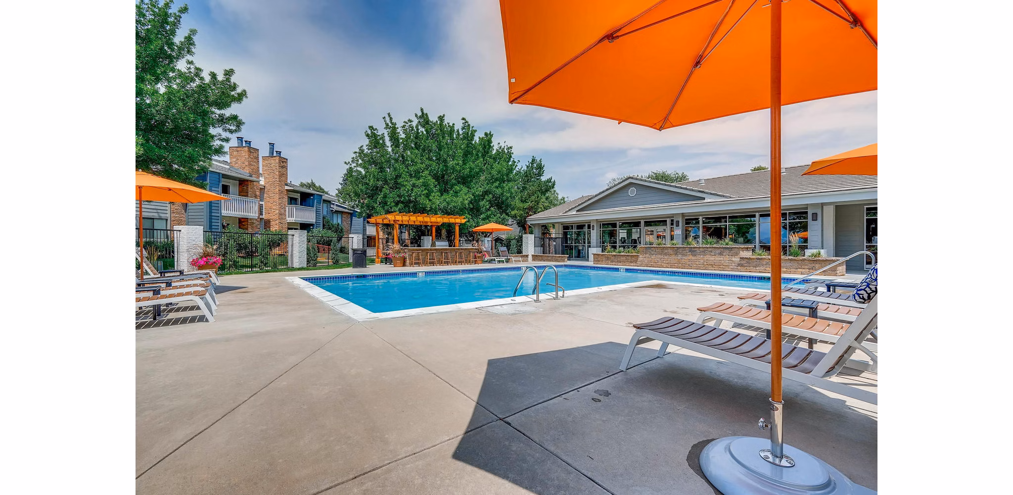Canyon Reserve: Tranquil pool area with lounge chairs at luxury apartments in a serene neighborhood