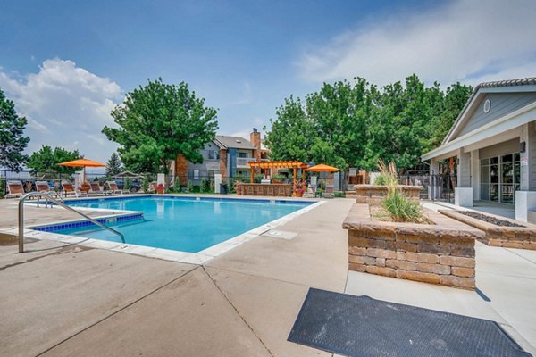 Luxurious outdoor pool area at Canyon Reserve at the Ranch Apartments, featuring modern lounge chairs and landscaped surroundings