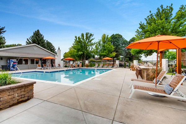 Resort-style pool surrounded by lush landscaping at Canyon Reserve at the Ranch Apartments