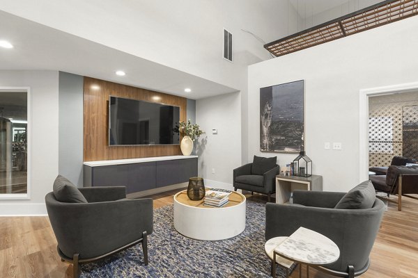 Modern clubhouse featuring cozy seating and entertainment options at Avana Star Lake Apartments