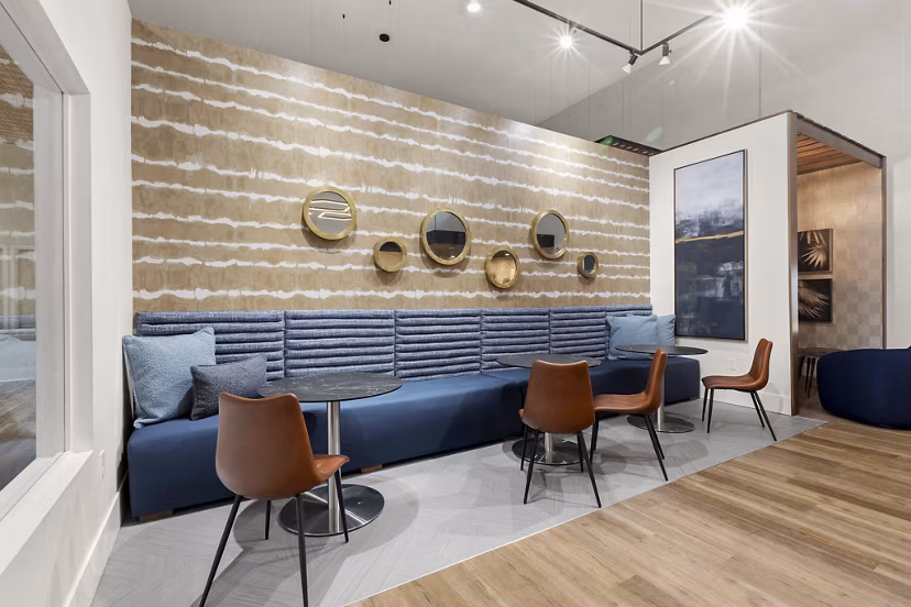 Clubhouse featuring modern design and cozy seating at Avana Star Lake Apartments Luxury community amenities for residents to enjoy