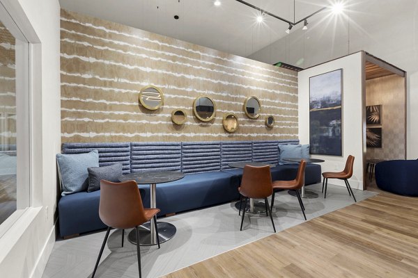 Clubhouse featuring modern design and cozy seating at Avana Star Lake Apartments Luxury community amenities for residents to enjoy