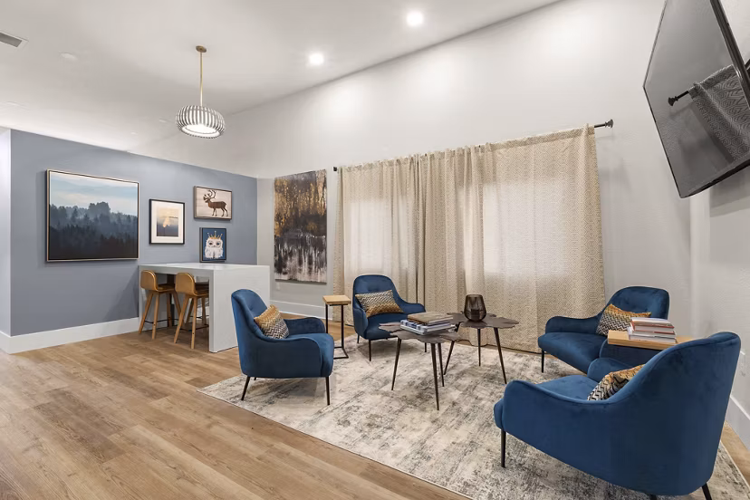 Modern clubhouse featuring luxury decor and seating at Avana Star Lake Apartments, ideal for social gatherings and leisure activities