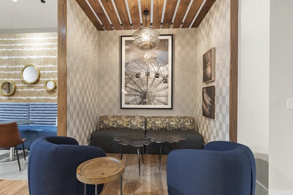Clubhouse featuring contemporary design and ample seating at Avana Star Lake Apartments