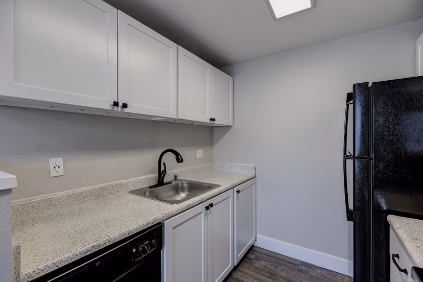 Modern kitchen with stainless steel appliances at Avana Star Lake Apartments, a Greystar property in a luxury setting