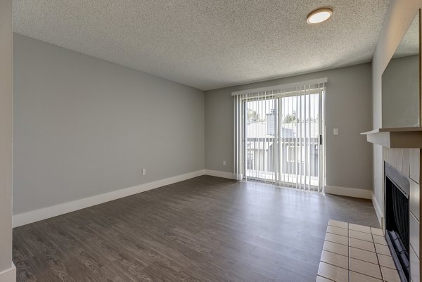 Modern living room with large windows at Avana Star Lake Apartments, featuring stylish decor and ample natural light