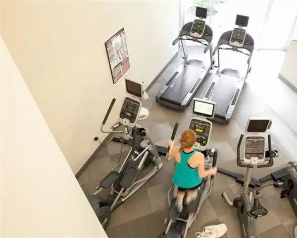 Modern fitness center equipped with state-of-the-art machines at On the Park Apartments