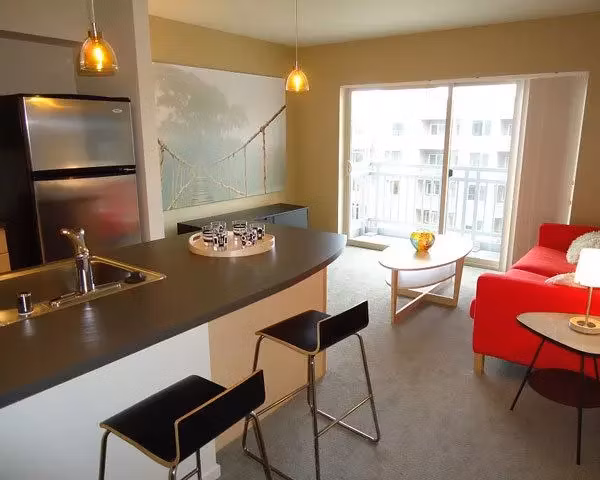 Modern kitchen with stainless steel appliances and granite countertops at On the Park Apartments