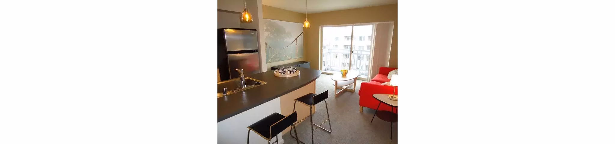Modern kitchen with stainless steel appliances and granite countertops at On the Park Apartments