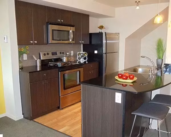 Modern kitchen with stainless steel appliances at On the Park Apartments, luxury living in the heart of downtown