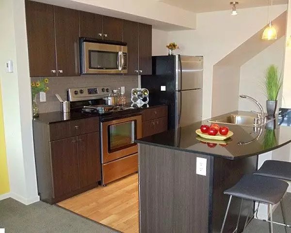 Modern kitchen with stainless steel appliances at On the Park Apartments, luxury living in the heart of downtown