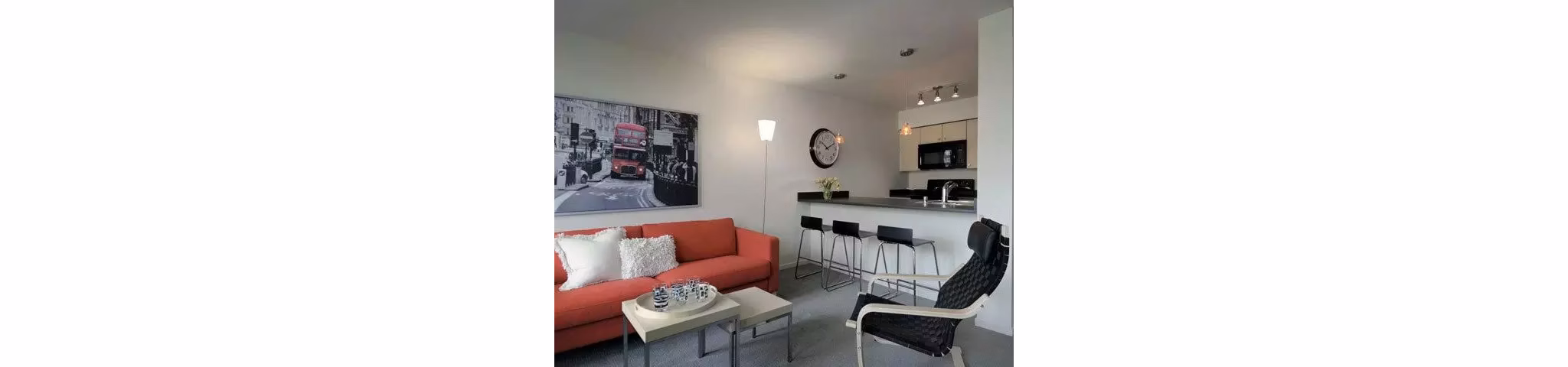 Spacious living room with modern decor and natural light at On the Park Apartments