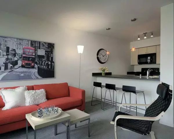 Spacious living room with modern decor and natural light at On the Park Apartments