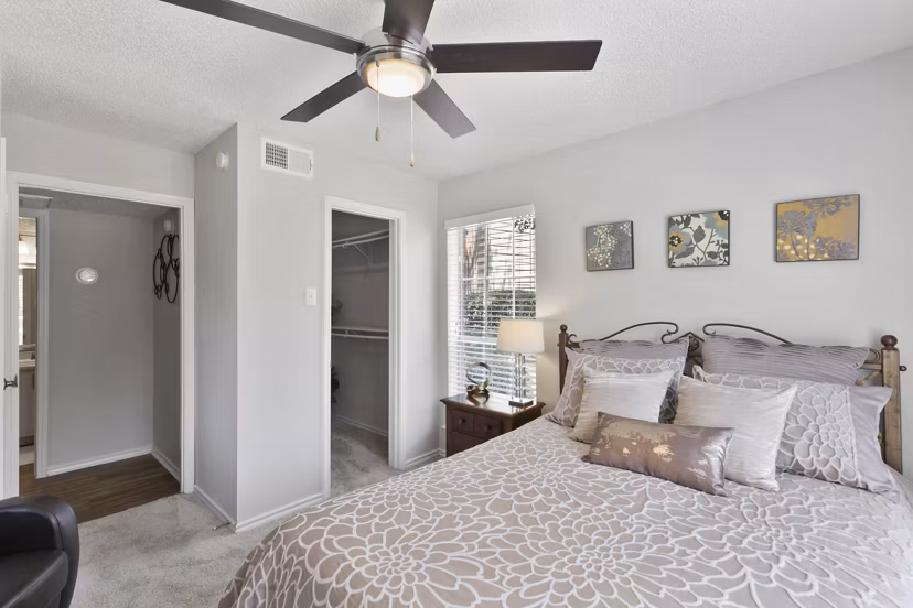 Cozy bedroom with plush furnishings at Creekwood Apartments, featuring Greystar luxury apartments' signature comfort and style