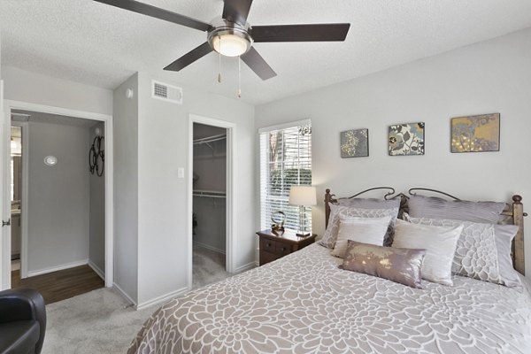 Cozy bedroom with plush furnishings at Creekwood Apartments, featuring Greystar luxury apartments' signature comfort and style