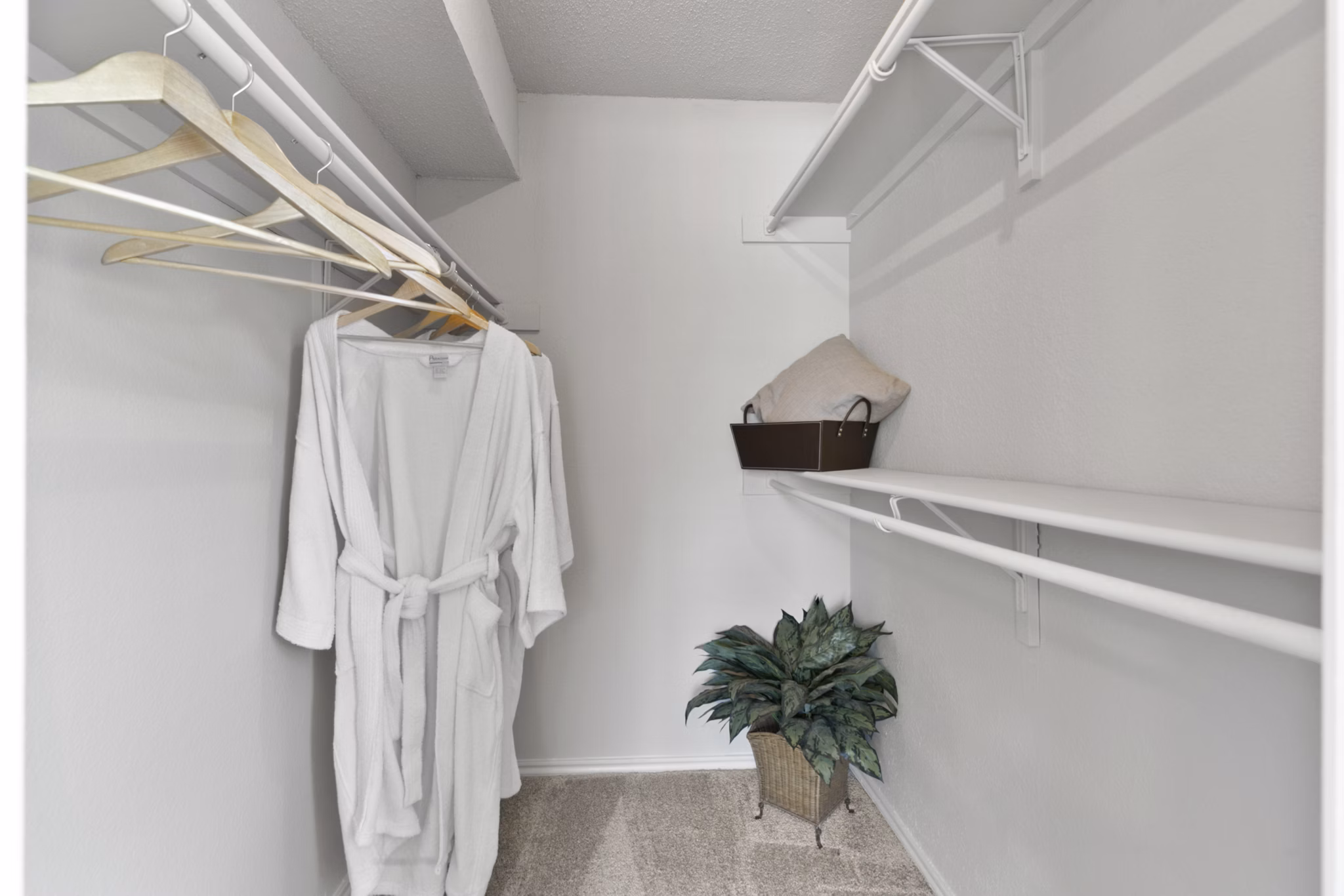 Modern closet space featuring ample storage options in Creekwood Apartments