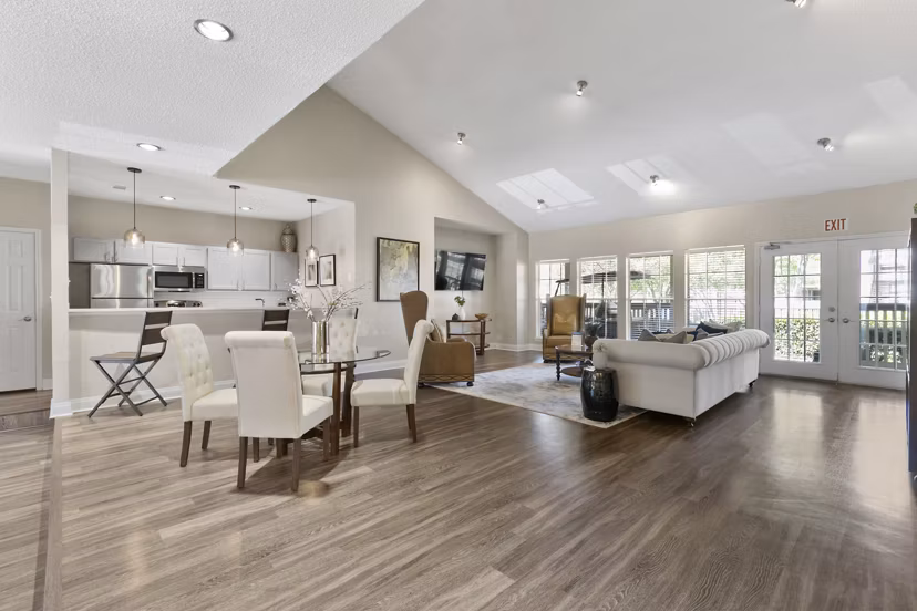 Clubhouse with modern furnishings and expansive windows at Creekwood Apartments