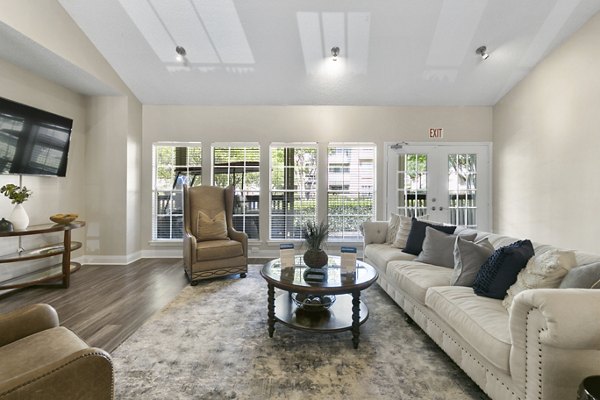 Clubhouse featuring modern design and cozy seating at Creekwood Apartments