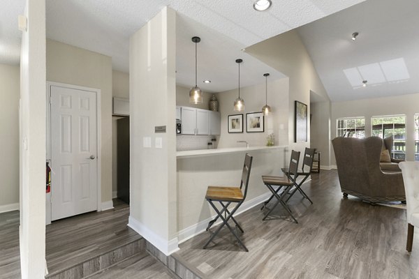 Modern clubhouse featuring a fireplace and lounge seating at Creekwood Apartments, creating a welcoming community space for residents