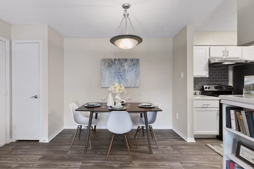 Dining area featuring modern furniture and natural lighting at Creekwood Apartments luxury homes