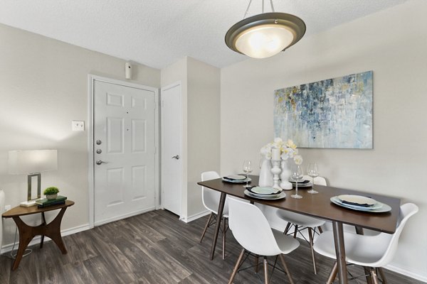 Dining area with modern furnishings in Creekwood Apartments, featuring stylish decor and ample natural light