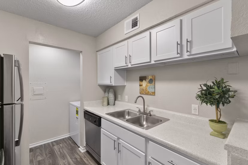 Modern kitchen with stainless steel appliances at Creekwood Apartments