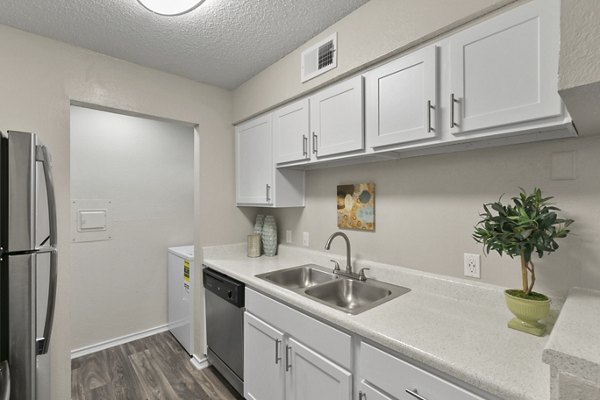 Modern kitchen with stainless steel appliances at Creekwood Apartments