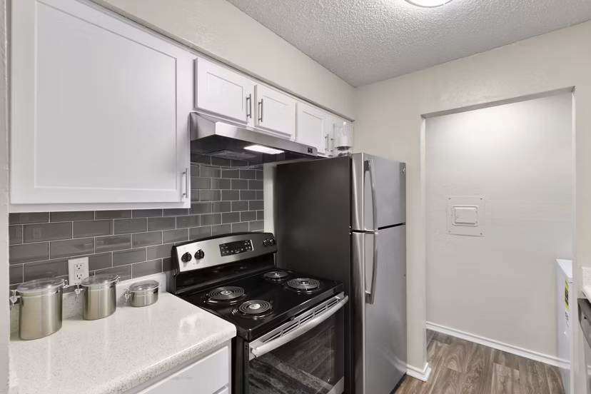 Modern kitchen featuring stainless steel appliances at Creekwood Apartments